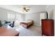 Bedroom with a bed, desk, dresser, tv, and window, creating a cozy and functional living space at 1925 Old Parsonage Rd, Charleston, SC 29414