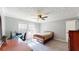 Cozy bedroom featuring neutral walls, a ceiling fan, and a functional desk area with natural light at 1925 Old Parsonage Rd, Charleston, SC 29414