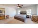 Carpeted main bedroom with a ceiling fan, windows and en-suite bath at 1925 Old Parsonage Rd, Charleston, SC 29414