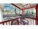 Covered back porch with comfortable seating and a view of the fenced backyard and mature trees at 1925 Old Parsonage Rd, Charleston, SC 29414