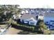 Birds-eye view of a gray-roofed, white-sided home with a manicured backyard featuring a patio and sun umbrella at 2009 Utsey St, Johns Island, SC 29455