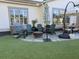 Cozy backyard patio with a stone fire pit, comfortable Adirondack chairs, and artificial turf at 2009 Utsey St, Johns Island, SC 29455