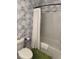 Well-decorated bathroom showcasing a patterned wallpaper with a shower and toilet at 2009 Utsey St, Johns Island, SC 29455