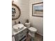 Charming powder room with stylish vessel sink, rope-trimmed mirror and beach-themed artwork at 2009 Utsey St, Johns Island, SC 29455