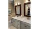 Clean and modern bathroom featuring dual sinks, granite countertops, and bronze fixtures at 2009 Utsey St, Johns Island, SC 29455