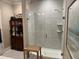 Bathroom features a glass-enclosed tile shower, complemented by a wooden bench and well-organized storage at 2009 Utsey St, Johns Island, SC 29455
