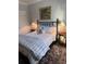 Charming bedroom features an iron bed frame, side tables, and decorative rug adding a cozy touch at 2009 Utsey St, Johns Island, SC 29455