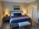 Calm bedroom with warm, leafy wallpaper and a large comfortable bed at 2009 Utsey St, Johns Island, SC 29455