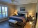 Comfortable bedroom includes natural light, bedside tables, and an upholstered bench at 2009 Utsey St, Johns Island, SC 29455