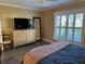 Bedroom with wood floor, window with shutters and a large chest of drawers at 2009 Utsey St, Johns Island, SC 29455