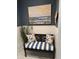 Charming entryway with a coastal-themed bench, providing a relaxing spot with stylish decor and artwork at 2009 Utsey St, Johns Island, SC 29455