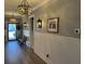 Foyer with oyster shell chandeliers, bench, and wainscoting for an inviting entry at 2009 Utsey St, Johns Island, SC 29455