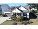 View of home featuring a well manicured lawn, a 2 car garage, and beautiful landscaping at 2009 Utsey St, Johns Island, SC 29455
