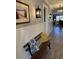 Hallway featuring light gray walls, wainscoting, wood floors, and decorative lighting at 2009 Utsey St, Johns Island, SC 29455