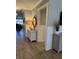 Hallway featuring warm neutral paint, paneled walls, and light wood flooring at 2009 Utsey St, Johns Island, SC 29455