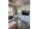 Cozy living room featuring shuttered windows, an entertainment center, and backyard access at 2009 Utsey St, Johns Island, SC 29455