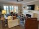 Spacious living room with many windows, fireplace, comfortable seating, and wood flooring at 2009 Utsey St, Johns Island, SC 29455