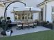 Outdoor dining area with a stylish table and chairs, complemented by lush green artificial turf at 2009 Utsey St, Johns Island, SC 29455