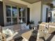 This outdoor porch features comfortable seating around a table and a view of the outdoors at 2009 Utsey St, Johns Island, SC 29455