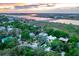An aerial view of a beautiful home with pool surrounded by trees near a bay and a scenic bridge at 204 E Huron Ave, Folly Beach, SC 29439