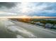Panoramic aerial view of oceanfront property with a beautiful beach and charming coastal homes at 204 E Huron Ave, Folly Beach, SC 29439