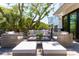 Comfortable outdoor deck with stylish seating, a center coffee table, and a lush tree canopy at 204 E Huron Ave, Folly Beach, SC 29439