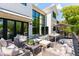 Spacious backyard deck featuring comfortable seating, an outdoor dining area, and modern home architecture at 204 E Huron Ave, Folly Beach, SC 29439