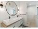 Modern bathroom with double sinks, sleek fixtures, and a glass-enclosed shower at 204 E Huron Ave, Folly Beach, SC 29439