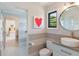 Modern bathroom with a vessel sink, circular mirror, and stylish gray accent wall at 204 E Huron Ave, Folly Beach, SC 29439