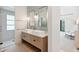 Modern bathroom featuring a double sink vanity, walk-in shower, and natural light at 204 E Huron Ave, Folly Beach, SC 29439