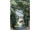 Scenic beach access path framed by lush greenery leading to the sandy shore at 204 E Huron Ave, Folly Beach, SC 29439