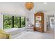 Bright bedroom with a beautiful window view, hardwood floors, and a woven pendant light fixture at 204 E Huron Ave, Folly Beach, SC 29439