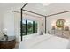 Bright bedroom with white linens, large windows, and light wood floors at 204 E Huron Ave, Folly Beach, SC 29439