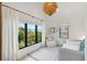 Bedroom with large windows providing natural light and views of the trees at 204 E Huron Ave, Folly Beach, SC 29439