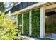 Charming exterior of a home featuring lush vertical gardens, stone pathways, and a welcoming ambiance at 204 E Huron Ave, Folly Beach, SC 29439