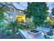 Captivating exterior view of a home with a fire pit, elegant landscaping, and a welcoming outdoor space at 204 E Huron Ave, Folly Beach, SC 29439