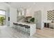 Modern kitchen island with bar seating, stylish pendants, and an open-concept layout at 204 E Huron Ave, Folly Beach, SC 29439