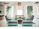 Inviting outdoor living area with stylish seating, a coffee table, and hanging woven light fixture at 204 E Huron Ave, Folly Beach, SC 29439