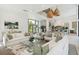 Open-concept living space with a luxurious sofa, dining table, and view of the gourmet kitchen at 204 E Huron Ave, Folly Beach, SC 29439