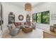 Living room featuring modern decor, neutral color palette, and a large window at 204 E Huron Ave, Folly Beach, SC 29439
