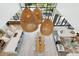 Open-concept space with a kitchen, dining table, and living area with large, hanging, basket-weave light fixtures at 204 E Huron Ave, Folly Beach, SC 29439