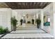 Elegant lobby with a geometric flooring, decorative potted plants, and hanging woven light fixtures at 204 E Huron Ave, Folly Beach, SC 29439
