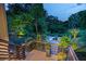 Cozy outdoor lounge area with a fire pit, surrounded by lush greenery and illuminated by soft lighting at 204 E Huron Ave, Folly Beach, SC 29439