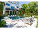 Stunning backyard features a modern pool with lounge chairs and lush landscaping, perfect for outdoor relaxation at 204 E Huron Ave, Folly Beach, SC 29439
