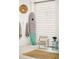 Relaxing room with a surfboard, hanging towels, a comfortable chair, and a woven pendant light fixture at 204 E Huron Ave, Folly Beach, SC 29439