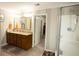 Bathroom featuring a dual vanity, a walk-in shower, and an open doorway with a peak into the walk-in closet at 2049 Maybelles Ln, Charleston, SC 29414