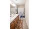 Well-lit bathroom featuring a double vanity, a large mirror, and a shower with a floral curtain at 2049 Maybelles Ln, Charleston, SC 29414