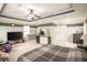 Open main bedroom with plush carpet, ceiling fan, large windows, modern furniture, and television at 2049 Maybelles Ln, Charleston, SC 29414
