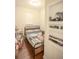 Compact bedroom space featuring a single bed, hardwood floors, and shelving unit at 2049 Maybelles Ln, Charleston, SC 29414