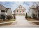 Charming two-story home with a well-manicured lawn and a two car garage with red shutters and beige colored siding at 2049 Maybelles Ln, Charleston, SC 29414